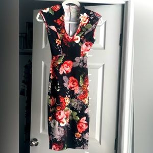 Sexy mid length floral dress. Form fitting stretchy material. Never worn.